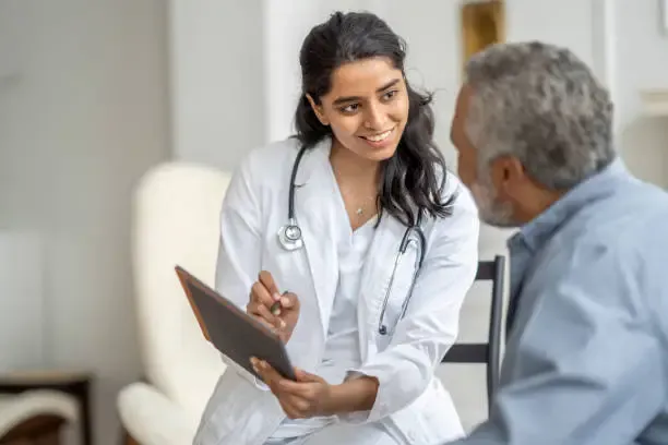 doctor providing compassionate home healthcare consultation to an elderly patient