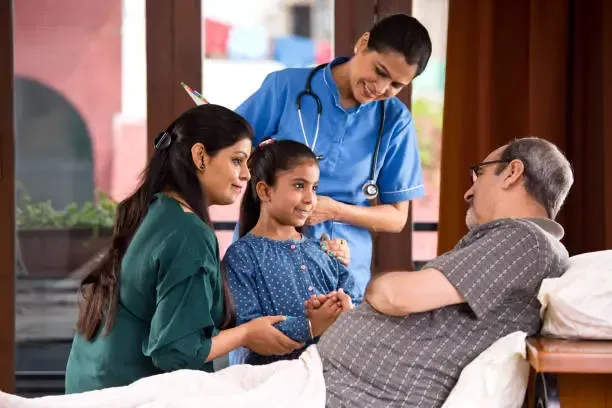 home nursing professional caring for an elderly patient with family support at home.